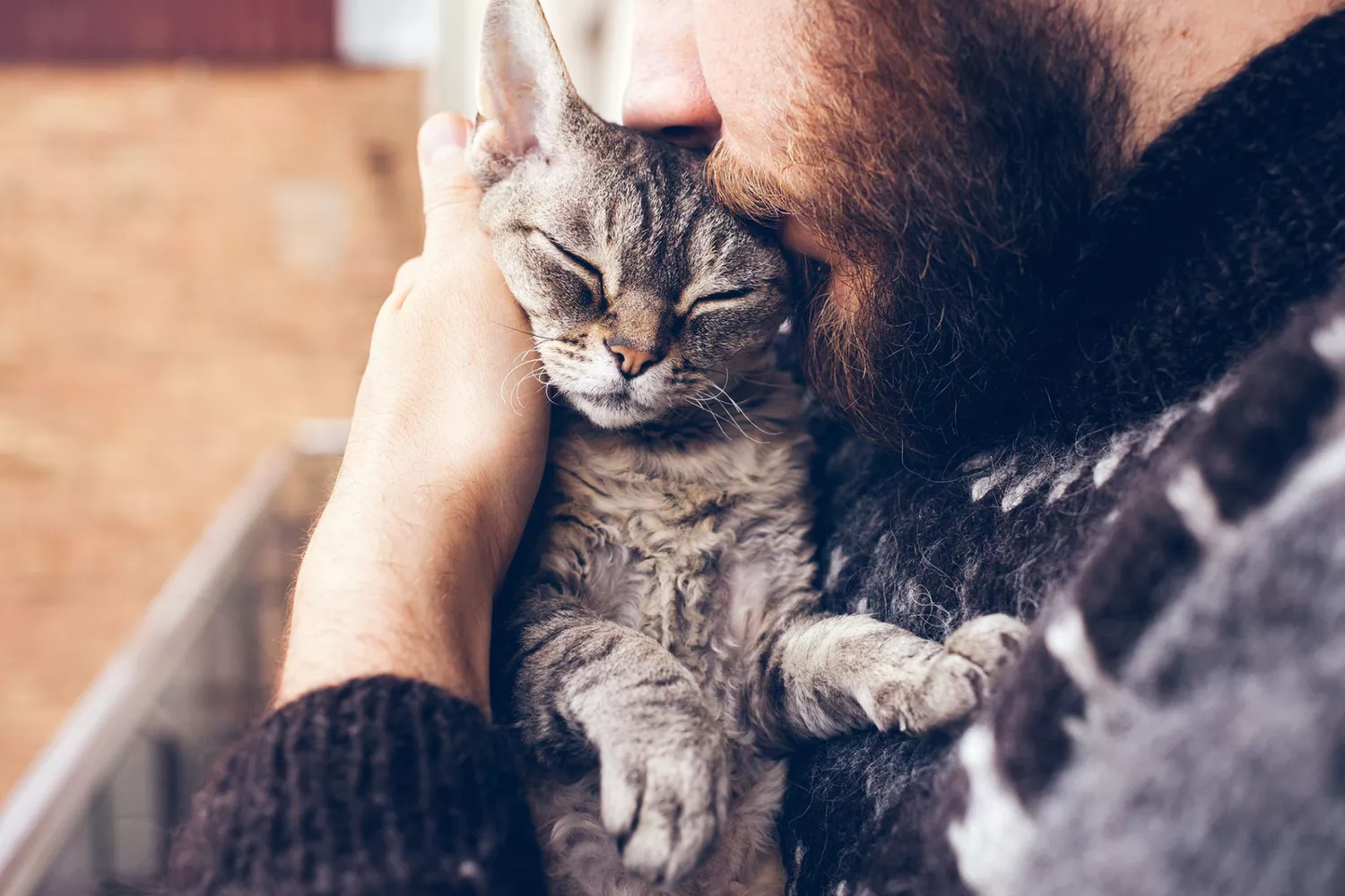 man comforting his cat